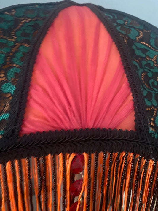 3. Detail view of the hand-pleated red chiffon sections, highlighting the soft texture and craftsmanship against the structured lace overlay