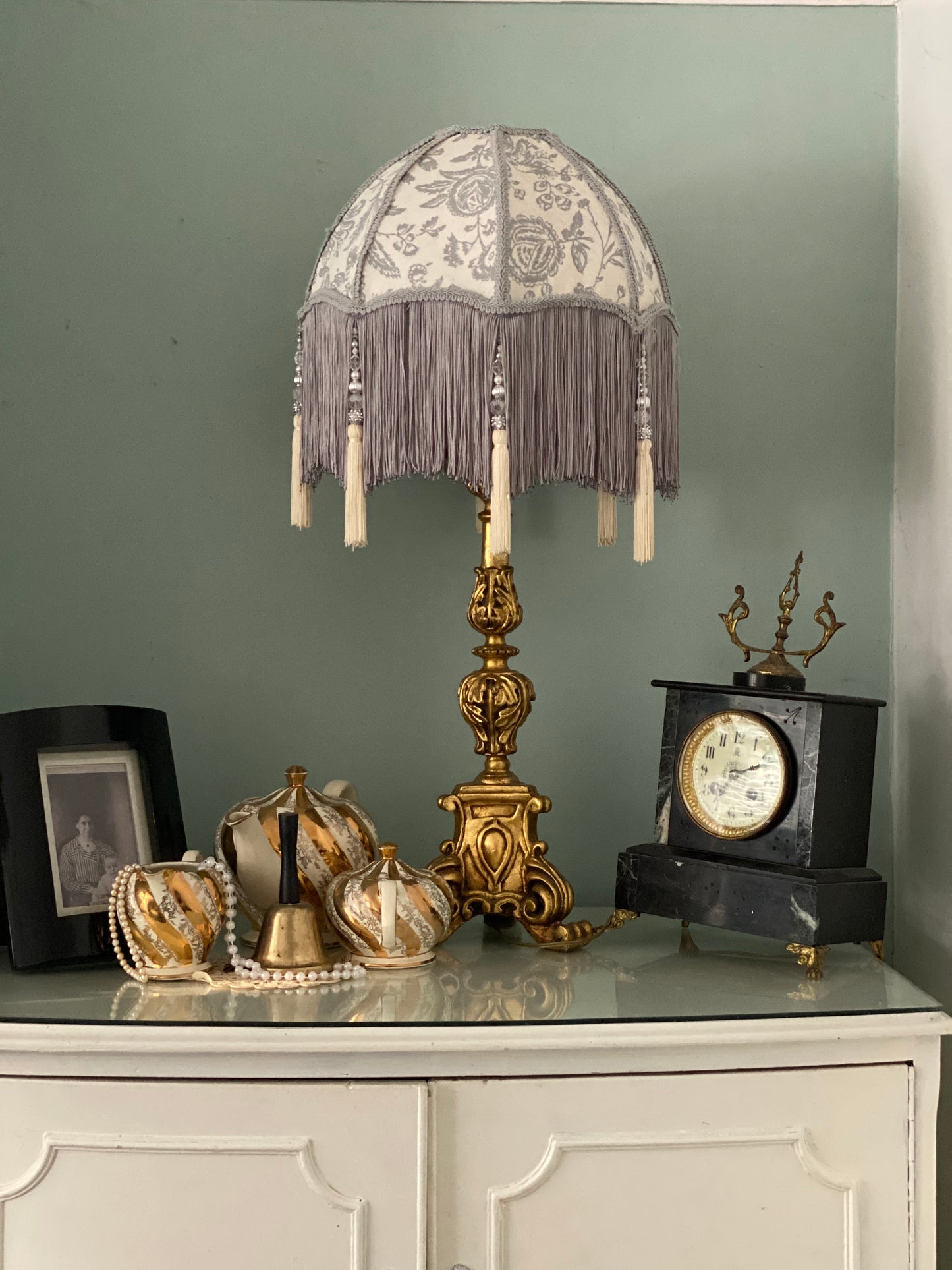 Full lampshade view – A grey Victorian parachute-style lampshade in blue toile fabric, with a soft scalloped shape and a long beaded fringe.