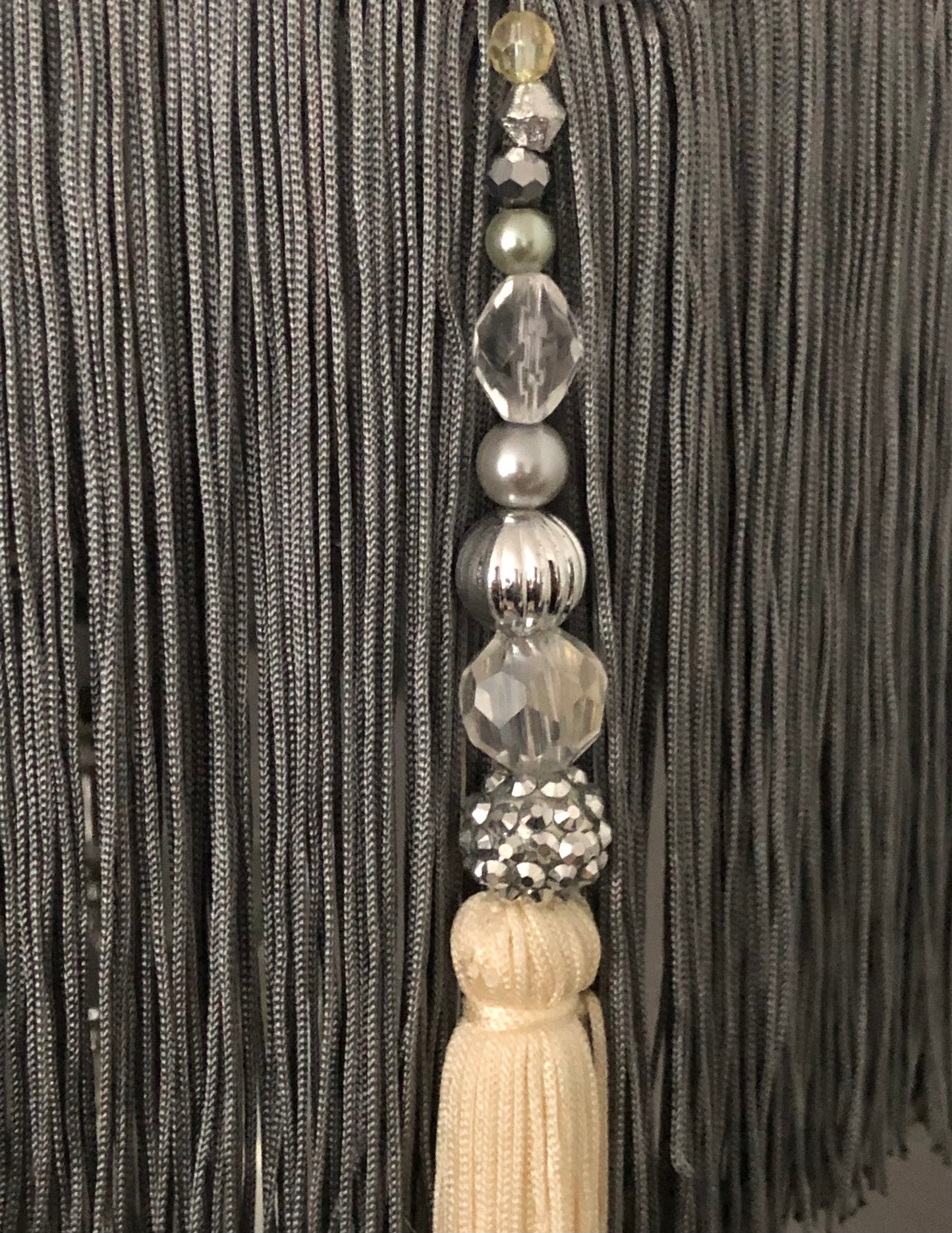 Decorative beads tassel close up and grey fringe