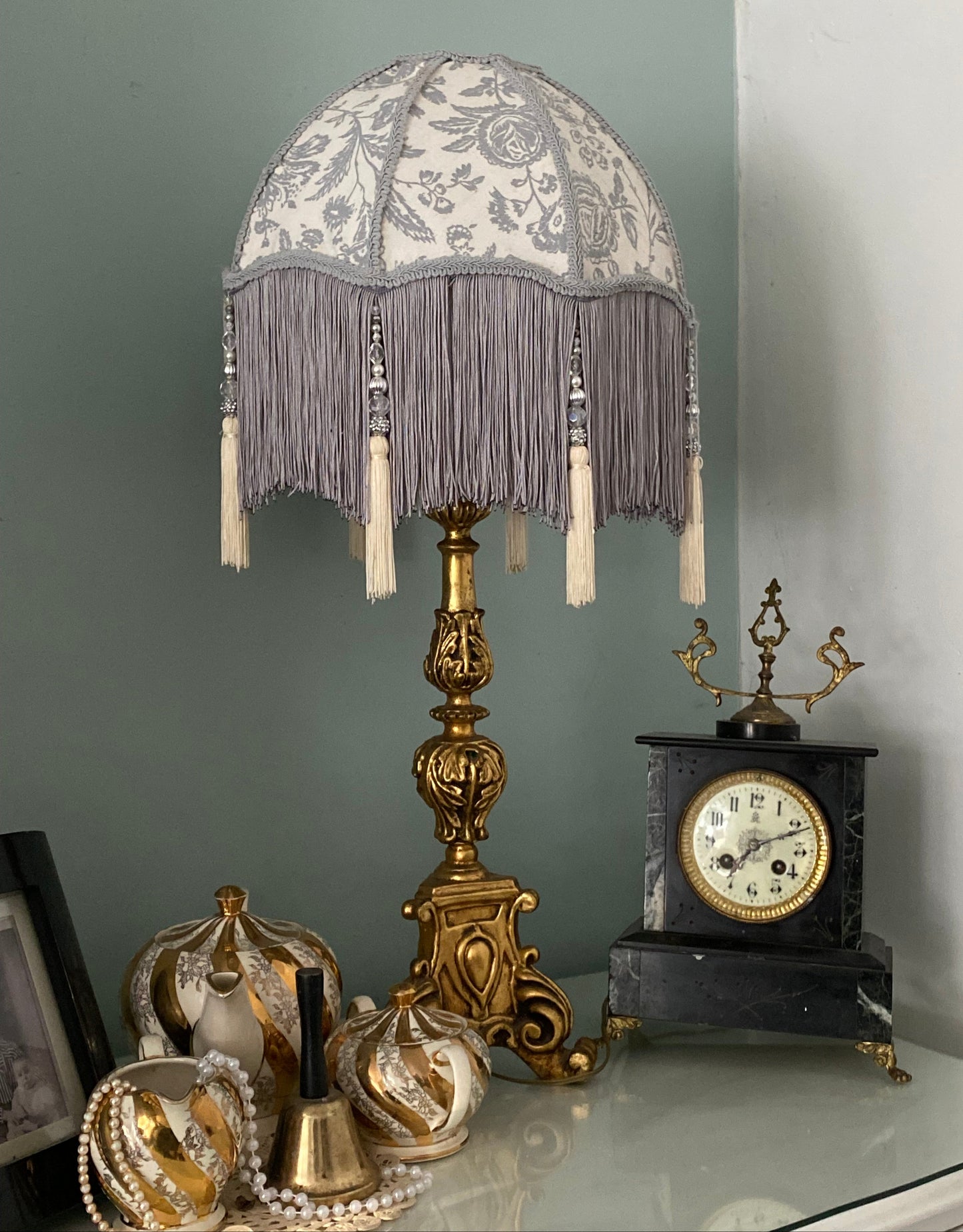 Full lampshade view – A grey Victorian parachute-style lampshade in blue toile fabric, with a soft scalloped shape and a long beaded fringe.