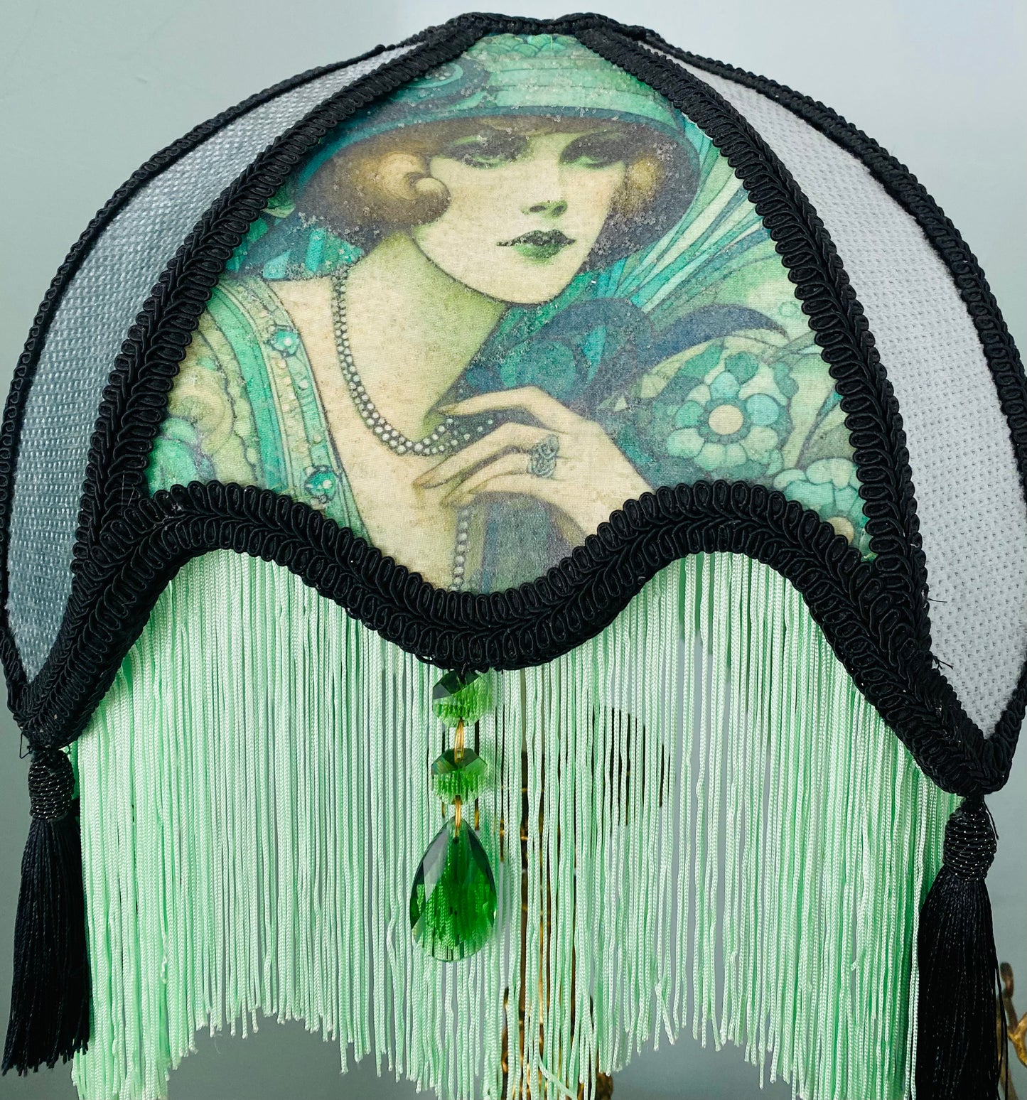 Close-up of Edwardian lady panel – “Detailed close-up of Edwardian lady picture framed by black lace and green silk panels on a handmade Victorian parlour lampshade.”