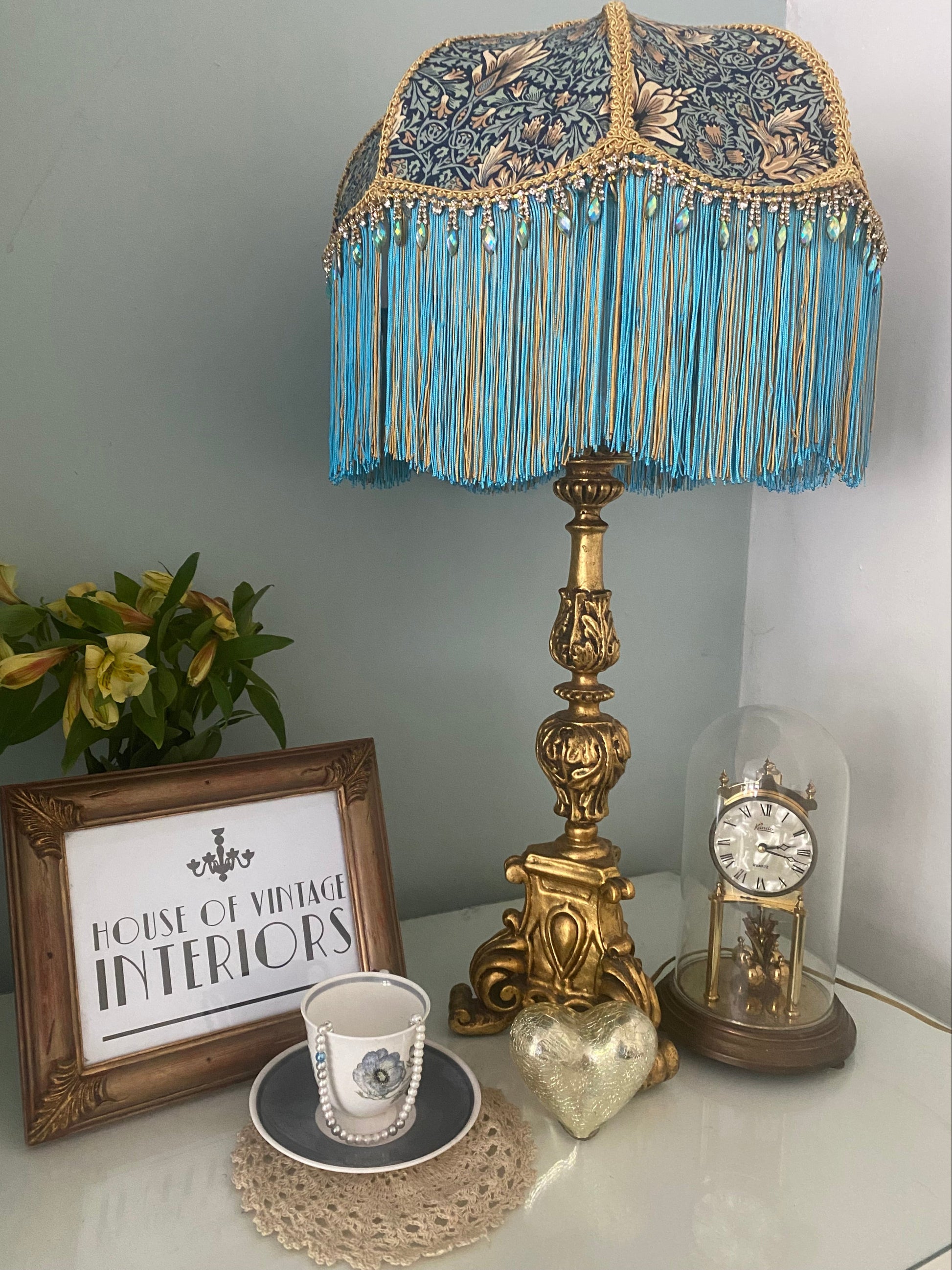 Full view, unlit
Handmade Art Deco fringed lampshade in William Morris “Snakeshead” turquoise fabric, with gold and turquoise two-tone fringe, gold braid trim, and sparkling iridescent diamantés — unique statement Victorian-inspired lighting.