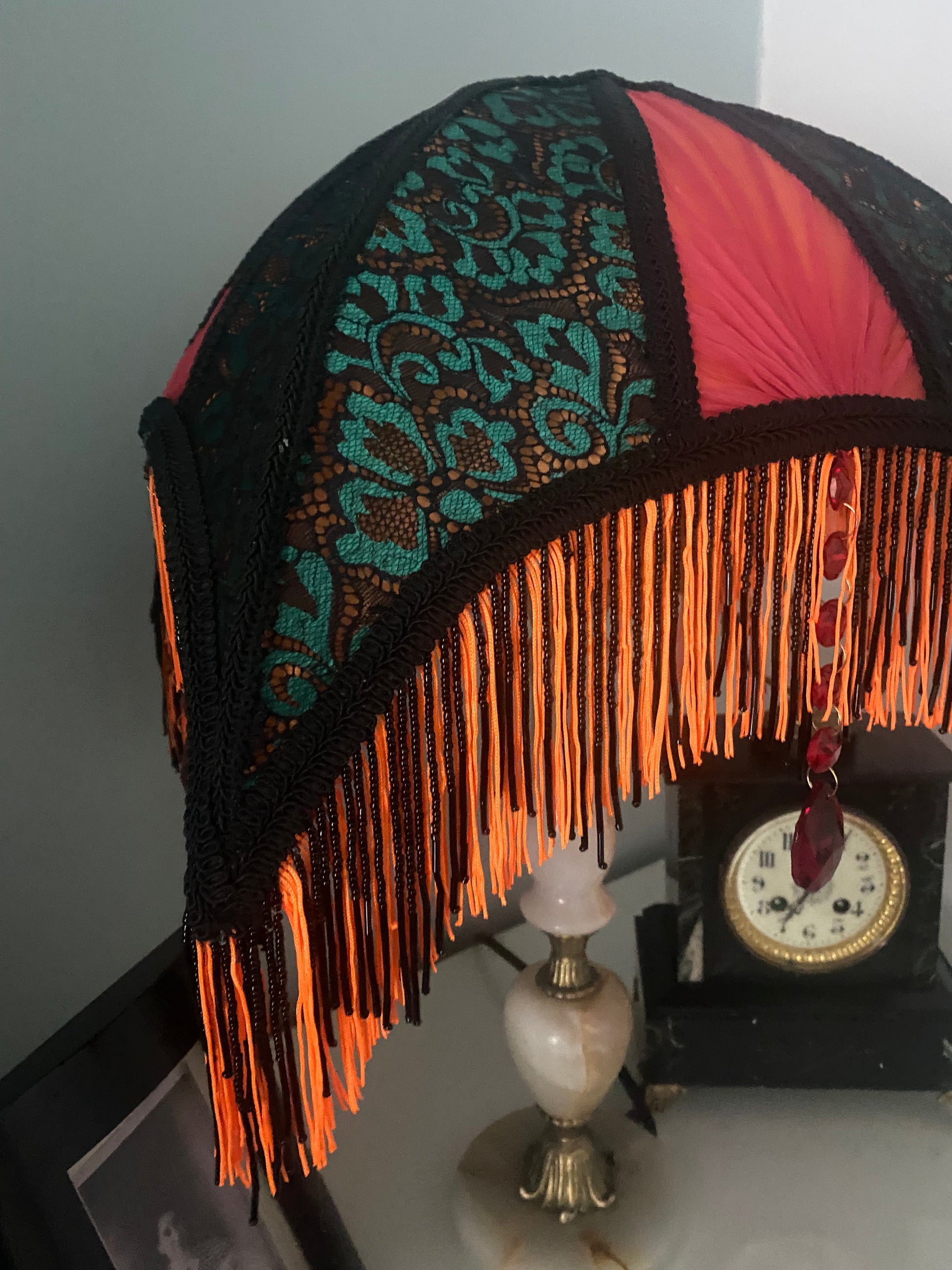 2. Close-up of the lampshade’s lace overlay, showing the intricate jade green and black lace patterns layered over vibrant orange silk.